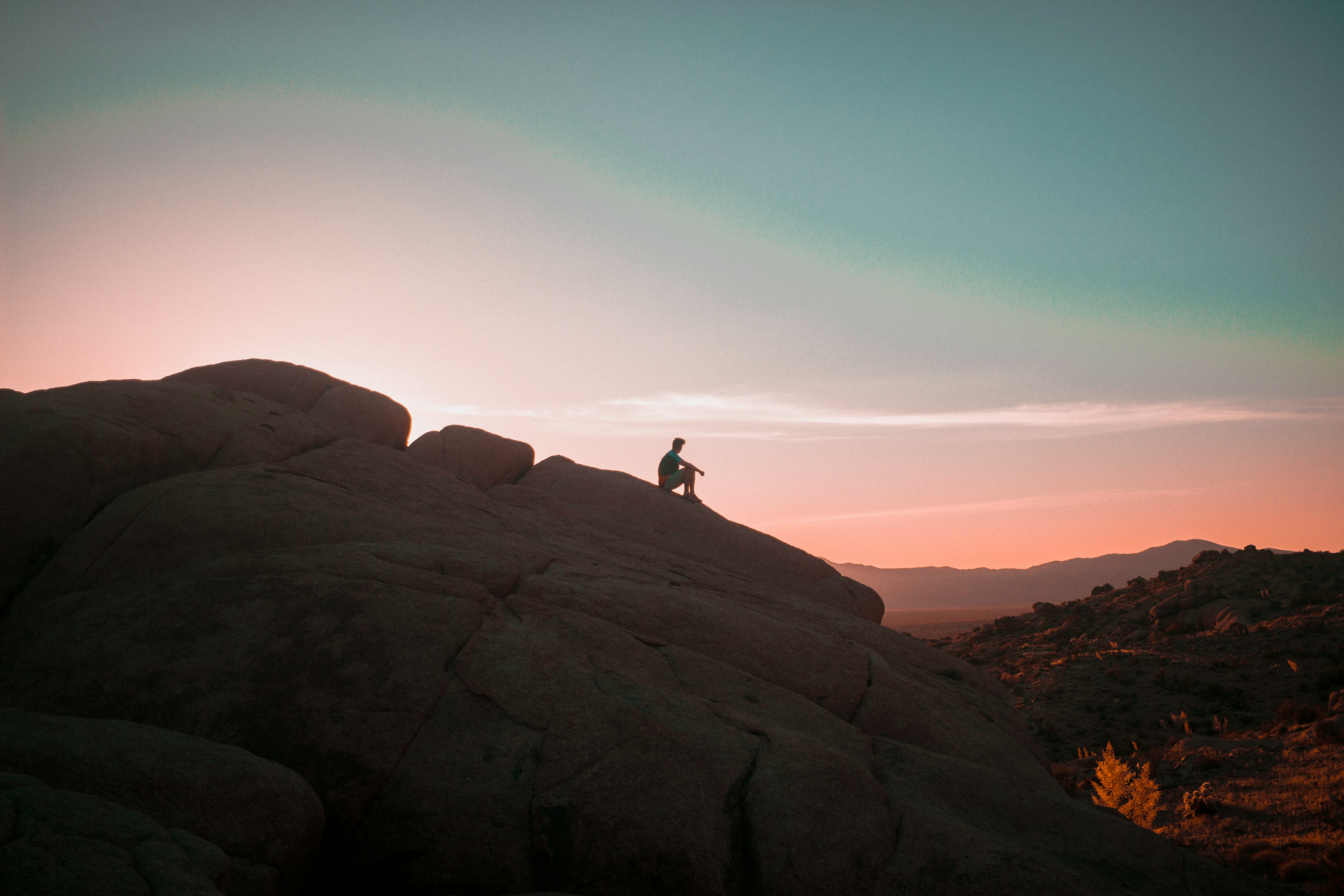 person sitting on rock